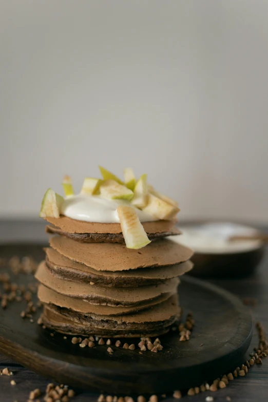 a stack of pancakes sitting on top of a black plate, inspired by Joris van der Haagen, apple, fuji choco, eco, thumbnail