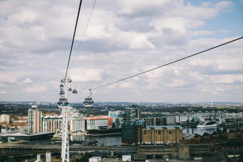 a view of a city from a cable car, pexels contest winner, the thames is dry, jen atkin, 🦩🪐🐞👩🏻🦳, clouds around