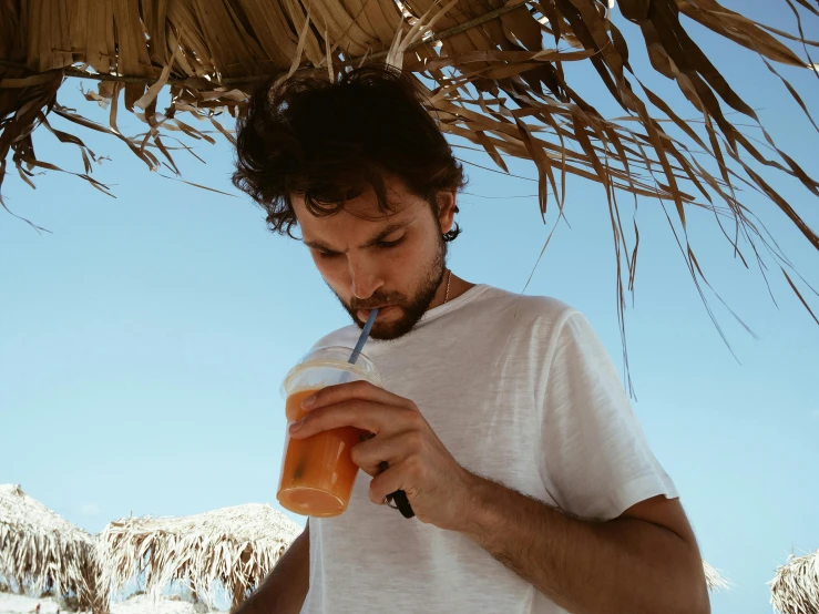 a man drinking a drink on the beach, pexels contest winner, young greek man, avatar image, straw, thumbnail