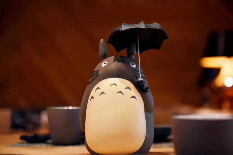 a close up of a totoro with an umbrella, mingei, mood light, black, kettle, medium