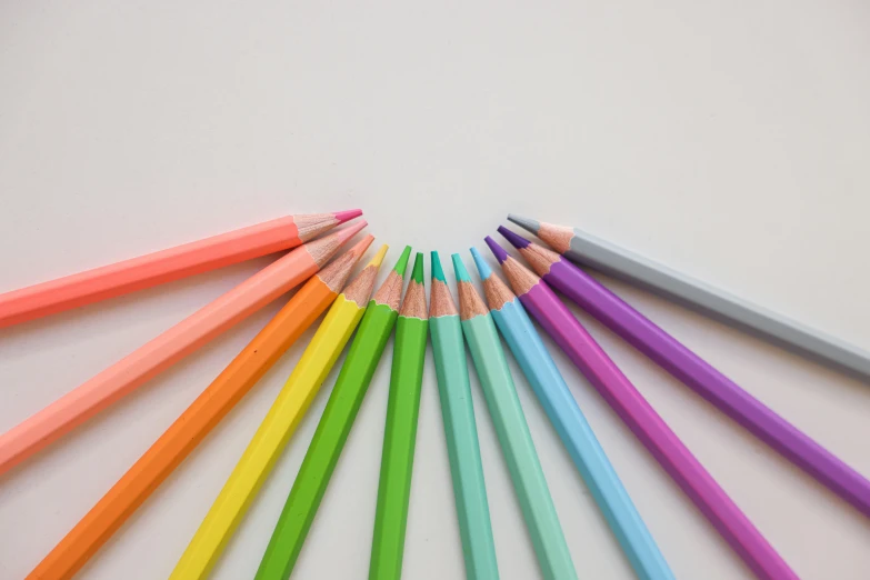 a group of colored pencils arranged in a circle, a color pencil sketch, by Rachel Reckitt, pexels, neon pastel, on grey background, colouring pages, low angle shot