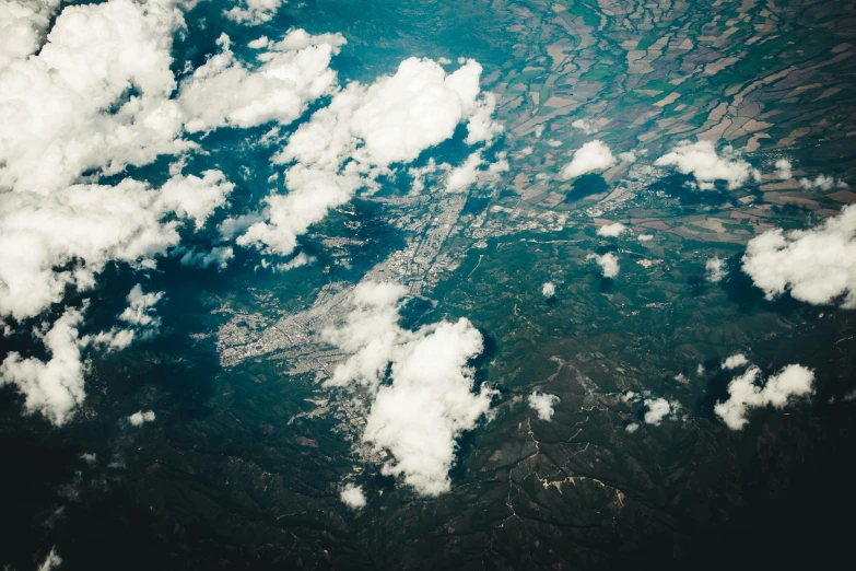 a view of the sky and clouds from an airplane, a picture, unsplash, renaissance, small town surrounding, earth visible below, alessio albi, a green