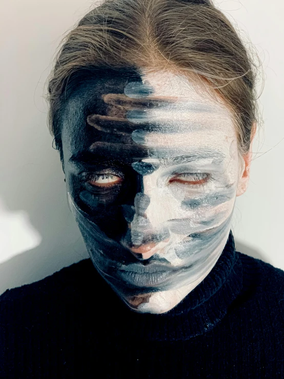 a close up of a person with a painted face, gradient black to silver, dasha taran, self deprecating, with differing emotions