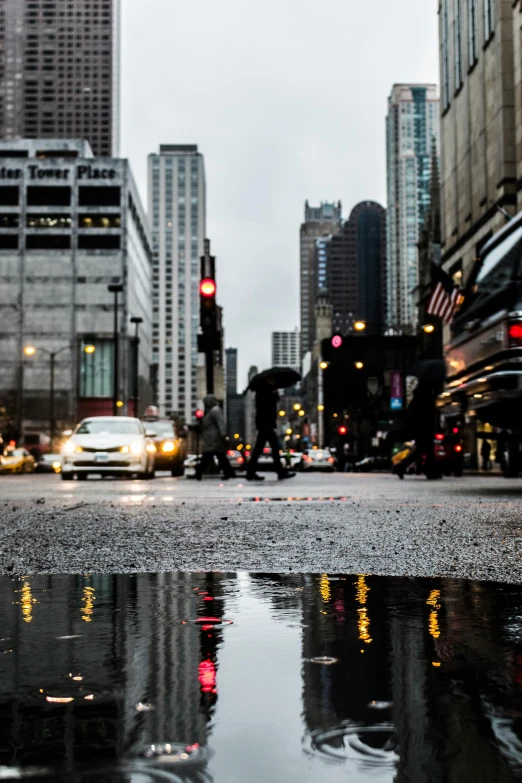 a city street filled with lots of traffic next to tall buildings, by Robbie Trevino, wet reflective ground, chicago, high quality image, multiple stories