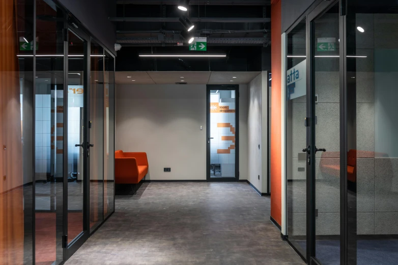 a hallway in an office with glass walls, private press, gray and orange colours, located in hajibektash complex, thumbnail, industrial aesthetic