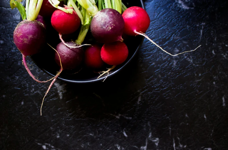 a bowl of radishes on a table, unsplash, process art, multiple stories, dark. no text, epicurious, magenta and blue