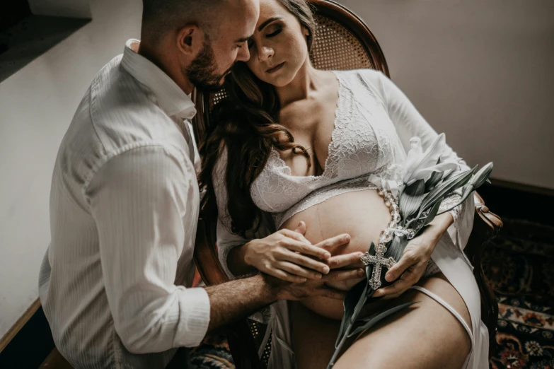 a pregnant woman sitting in a chair next to a man, pexels contest winner, avatar image, close body shot, boy and girl, lachlan bailey