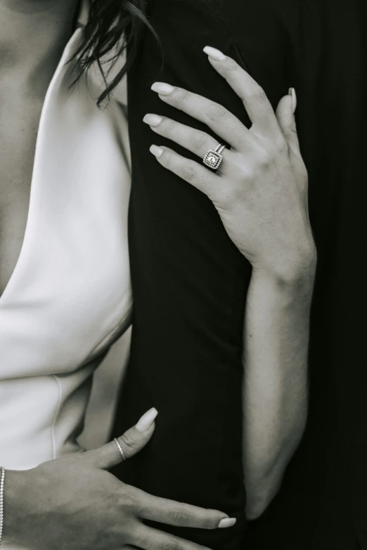 a black and white photo of a man and a woman, trending on unsplash, elegant hand, diamonds, large tall, embrace