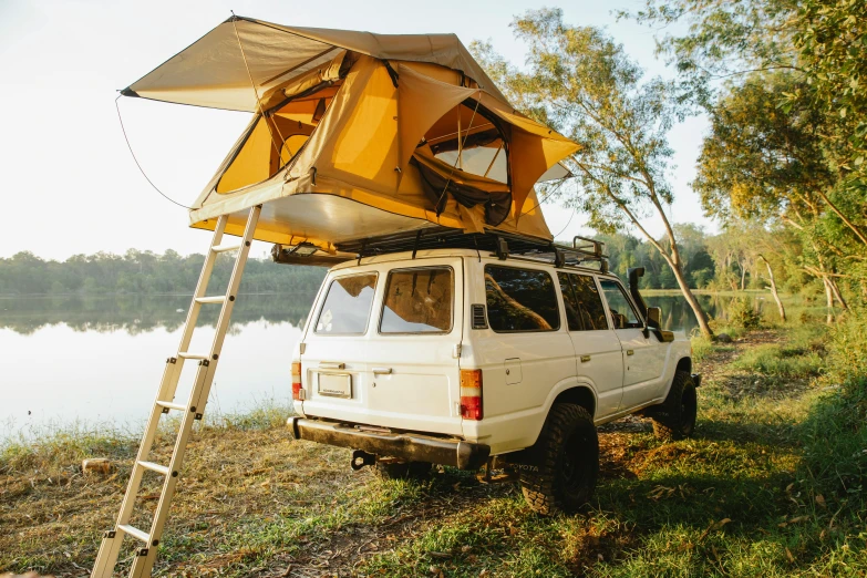 a white van parked next to a body of water, tent, vehicle, yellow theme, outdoor