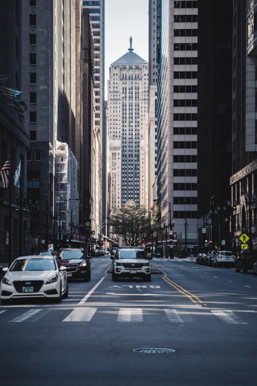 a city street filled with lots of tall buildings, by Daniel Seghers, pexels contest winner, car traffic, chicago, empty metropolitan street, square