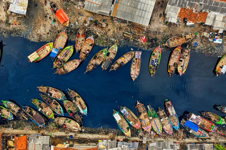 a group of boats sitting on top of a body of water, by Ibrahim Kodra, pexels contest winner, hurufiyya, the infrastructure of humanity, coloured, slide show, full frame image