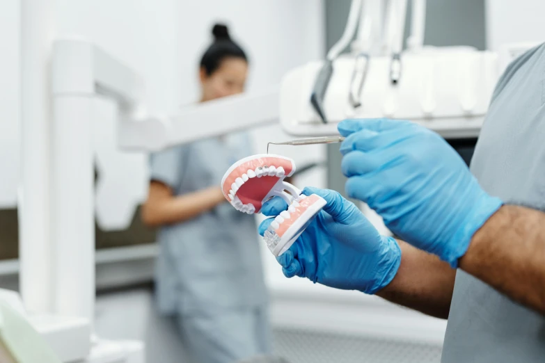 a close up of a person holding a toothbrush, surgery theatre, profile image, manly, in laboratory