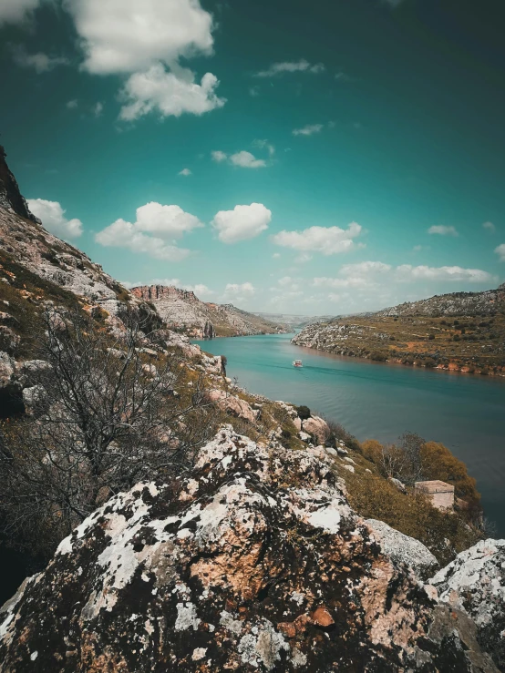 a large body of water sitting on top of a rocky hillside, by Muggur, pexels contest winner, romanticism, high quality product image”, today\'s featured photograph 4k, kurdistan, contrasted colors