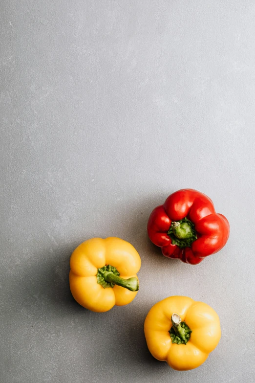 a group of peppers sitting on top of a table, a picture, unsplash, on a gray background, background image, 8 l, mix