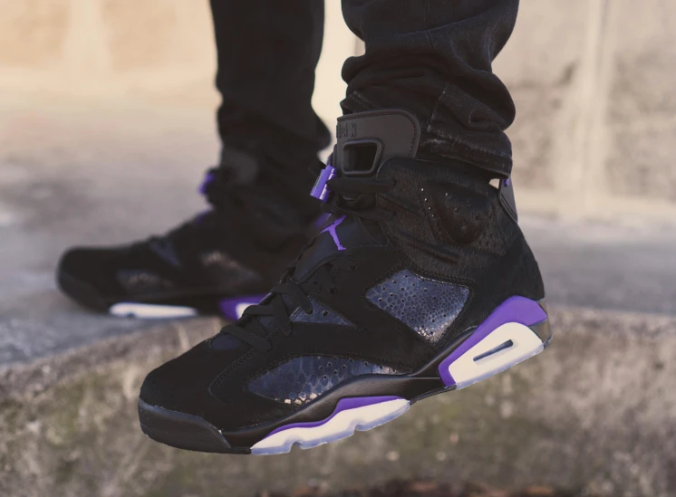 a person wearing a pair of black and purple sneakers, inspired by Jordan Grimmer, trending on pexels, smoke :6, arcane vi, expensive, grain”