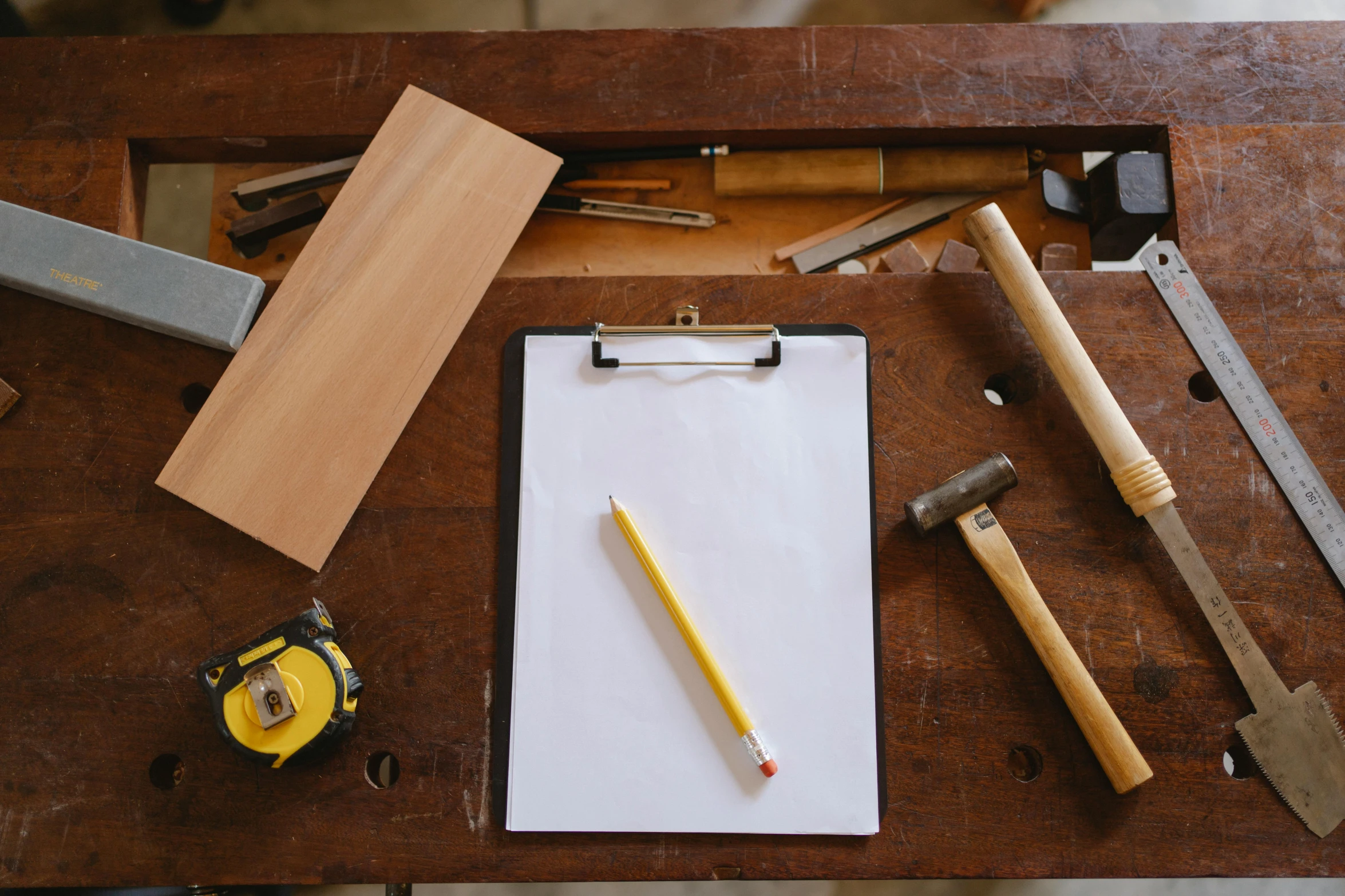 a clipboard sitting on top of a wooden table, a drawing, trending on pexels, arts and crafts movement, carpenter, shelf, thumbnail, woodlathe