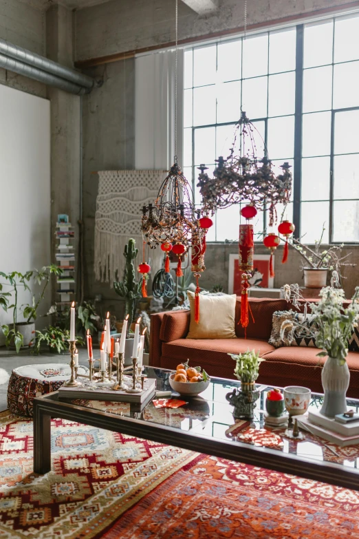 a living room filled with furniture and lots of plants, inspired by Riad Beyrouti, maximalism, chandeliers, red brown and grey color scheme, bay area, interior of a loft