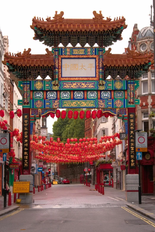 a chinese archway in the middle of a city street, inspired by Chang Dai-chien, london, festivals, square, maroon