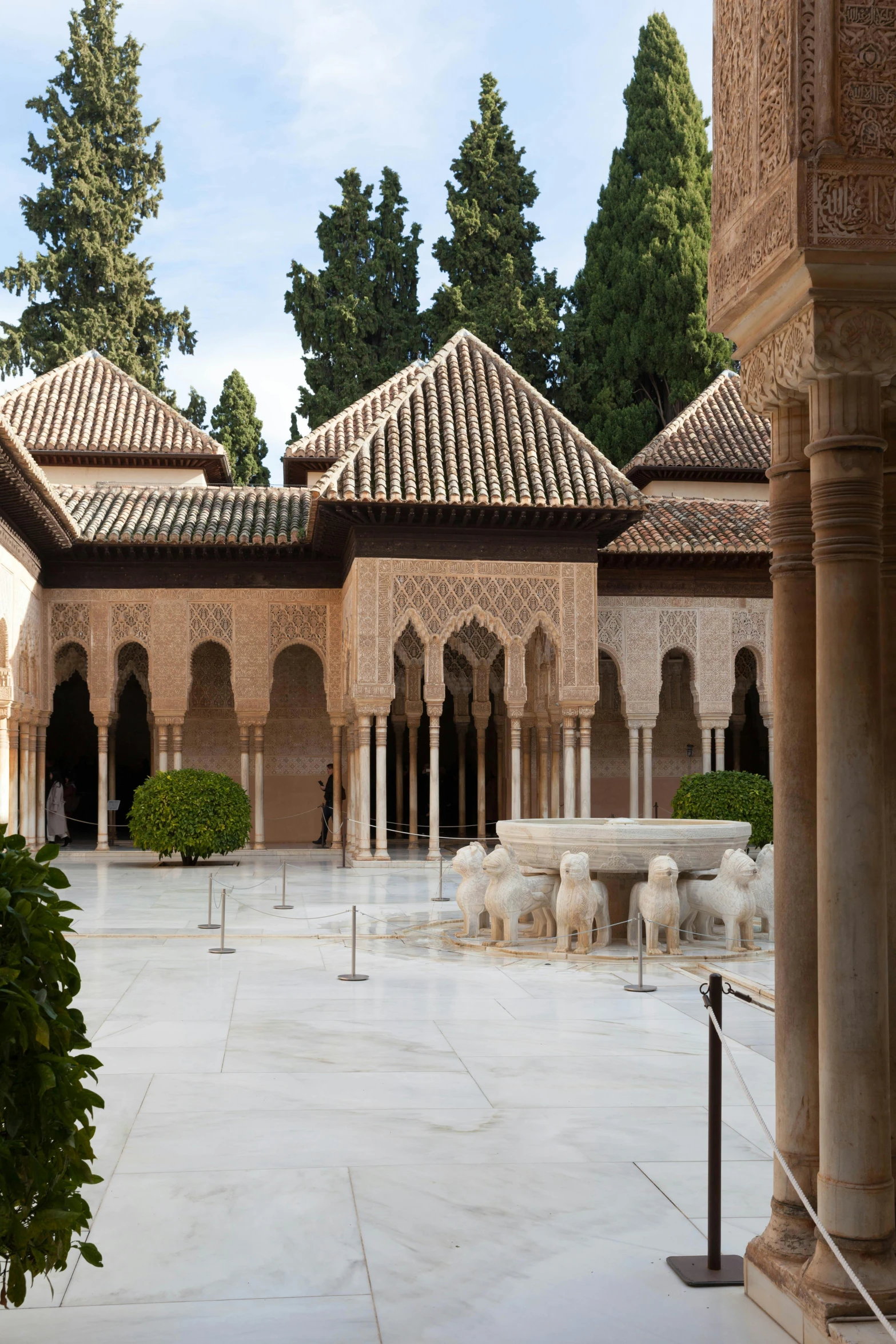 the courtyard of the alhambra palace in granada, spain, a marble sculpture, sleek spines, on a marble pedestal, peaked wooden roofs, white gallery