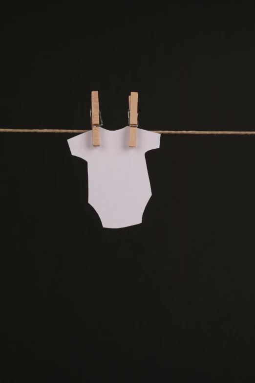 clothes hanging on a clothes line with clothes pegs, unsplash, conceptual art, diaper-shaped, on black background, bodysuit, on white paper