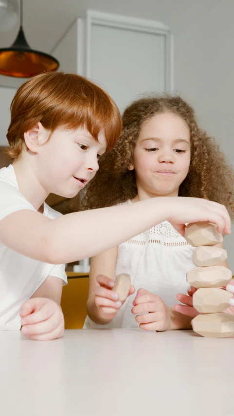 a group of children playing with a stack of doughnuts, by Alexander Brook, pexels, jenga tower, school curriculum expert, a wooden, thumbnail