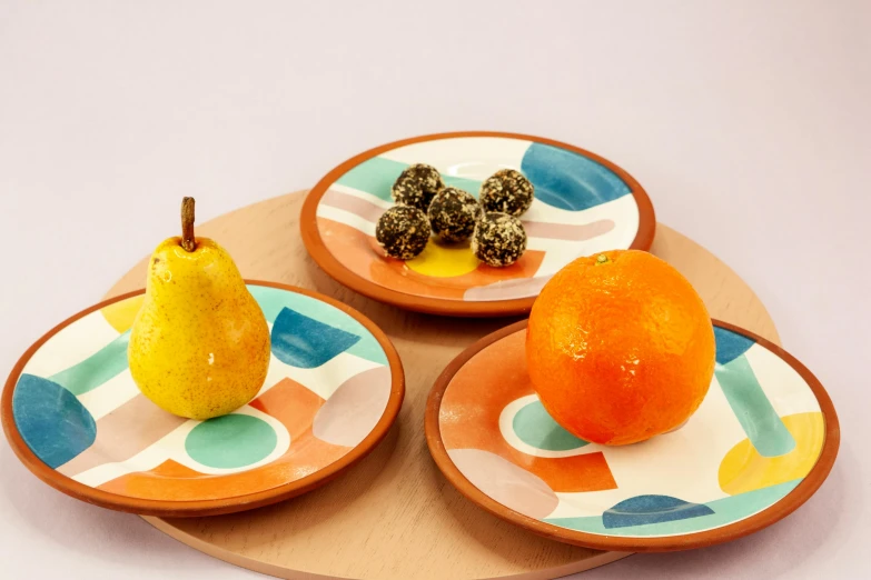 a close up of three plates with fruit on them, inspired by Sarah Morris, trending on dribble, terracotta, having a snack, cyan and orange, petite pear slim figure