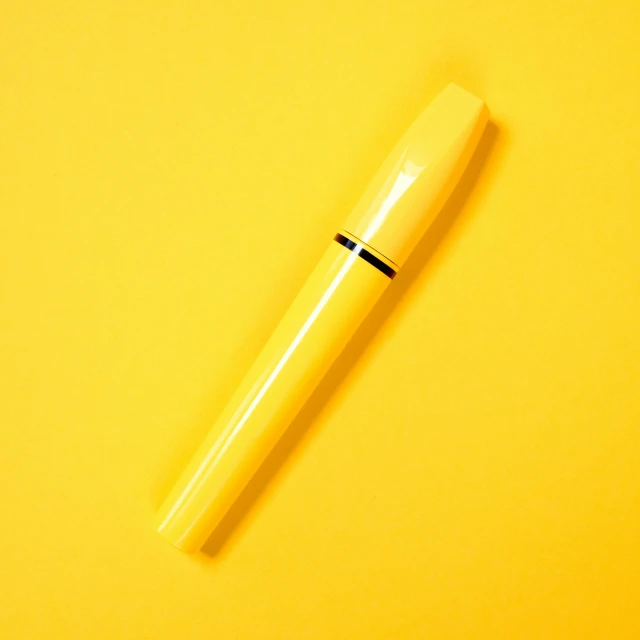 a yellow pen sitting on top of a yellow surface, heavy mascara, thumbnail, designer product, 1 2 9 7