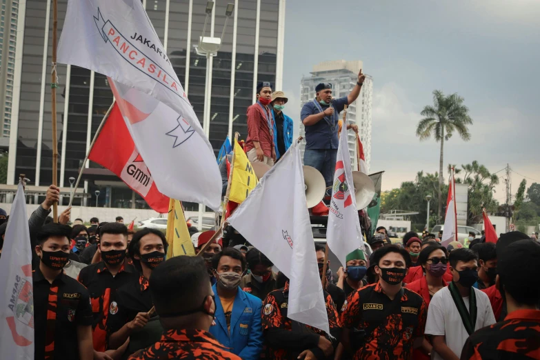 a group of people that are standing in the street, jokowi, flags, workers, background image