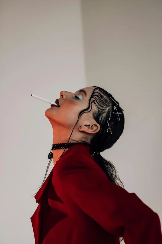 a woman with a cigarette in her mouth, an album cover, trending on pexels, surrealism, girl with plaits, red suit, photography of charline von heyl, at a fashion shoot