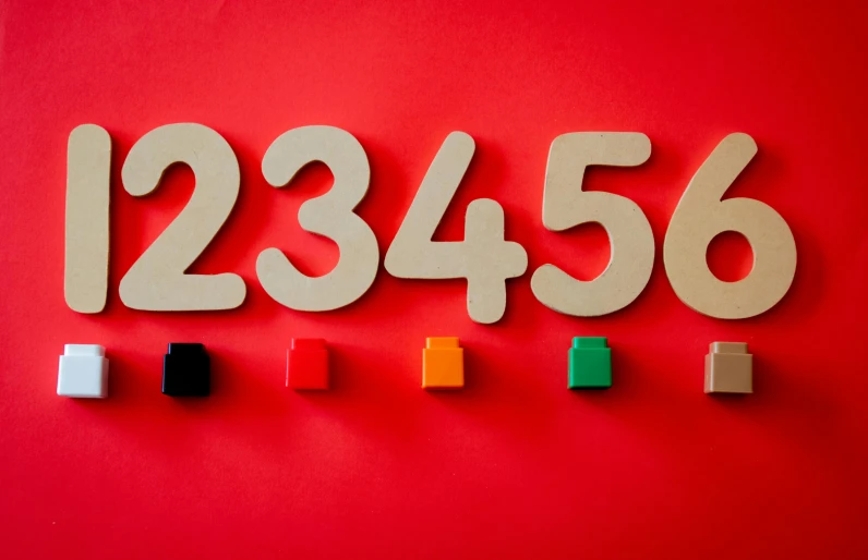 wooden numbers on a red background, trending on unsplash, academic art, 64x64, 2 5 6 colours, figures, red wall