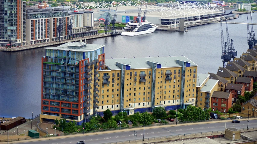 a city filled with lots of tall buildings next to a river, a photo, ten flats, argos, at the waterside, thumbnail