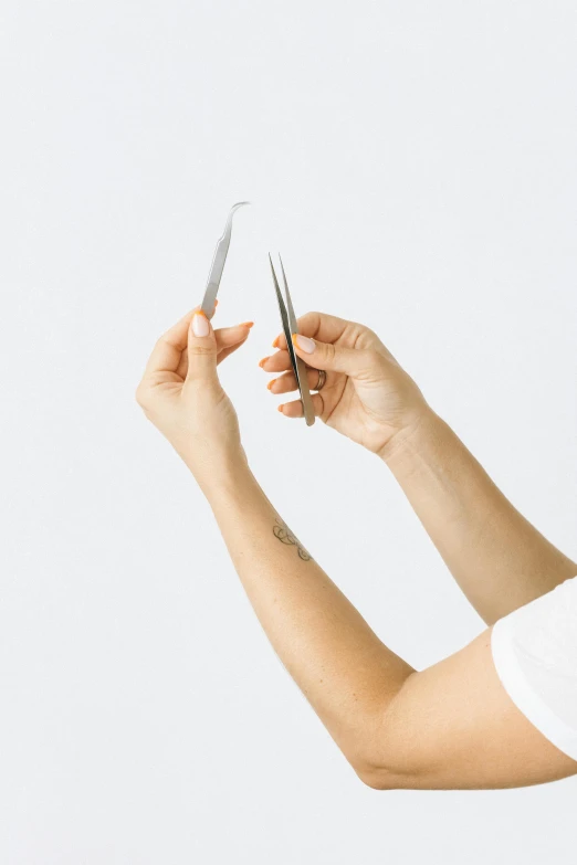 a woman holding a pair of scissors in one hand and a pair of scissors in the other, smooth streamline, detailing, minimal features, detailed product image