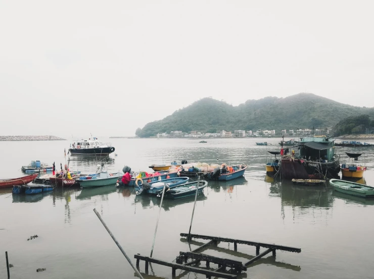 a number of boats in a body of water, pexels contest winner, jin shan, hazy and dreary, small port village, trending on vsco