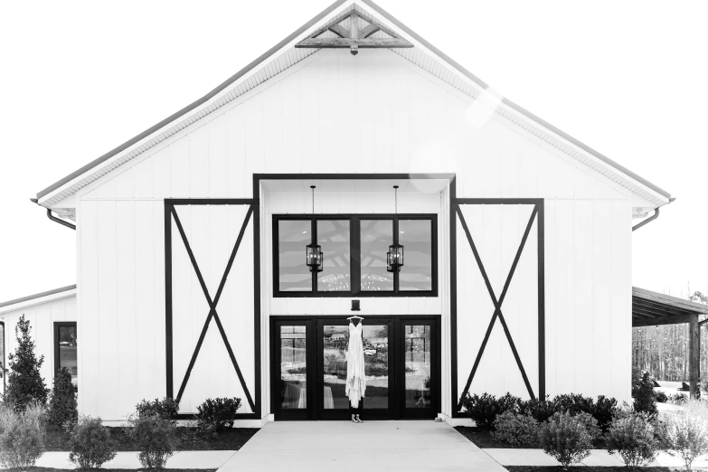 a black and white photo of a barn, a black and white photo, by Carey Morris, pexels, symmetrical doorway, joanna gaines, full body shots, chic