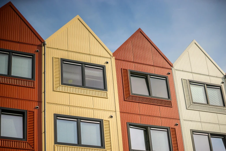 a row of multicolored houses next to each other, unsplash, modular constructivism, brown, iron cladding, grey