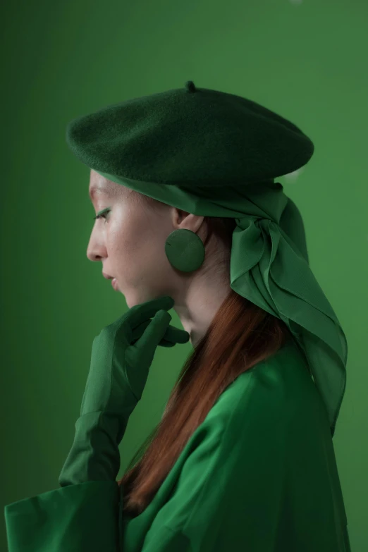 a woman wearing a green hat and gloves, an album cover, inspired by Art Green, trending on pexels, anna nikonova aka newmilky, giant earrings, marvelous designer, berets
