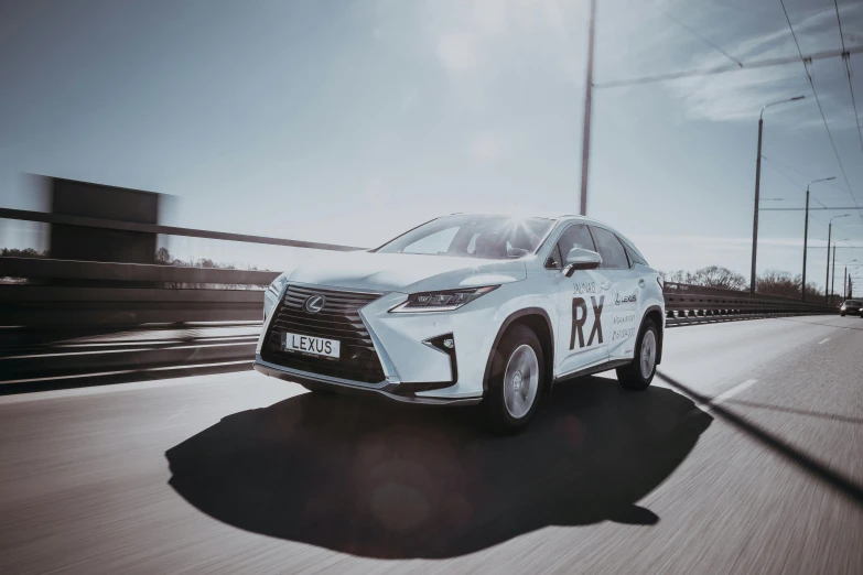 a white car driving down the road on a sunny day, a picture, by Adam Marczyński, pexels contest winner, hydrogen fuel cell vehicle, 2 5 6 x 2 5 6 pixels, rtx engine, medical