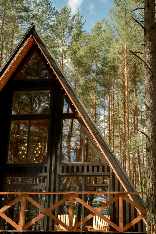 a small cabin sitting in the middle of a forest, triangular elements, profile image, holiday vibe, front lit