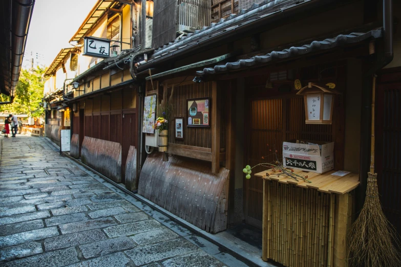 a street filled with lots of wooden buildings, inspired by Kanō Shōsenin, pexels contest winner, ukiyo-e, shop front, conde nast traveler photo, buildings carved out of stone, brown