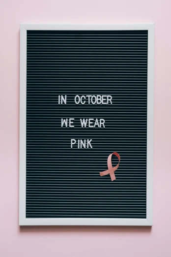 a letter board that says in october we wear pink, a cartoon, pexels, disease, instagram photo, black, fashionable