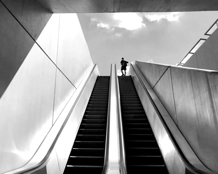 a black and white photo of a person on an escalator, beautiful day, hunting, instagram post, metro