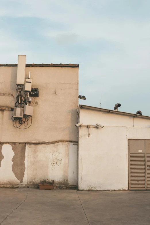 a man riding a skateboard up the side of a building, inspired by Zhang Kechun, unsplash, renaissance, satellite dishes, trending photo, in spain, machinery and wires