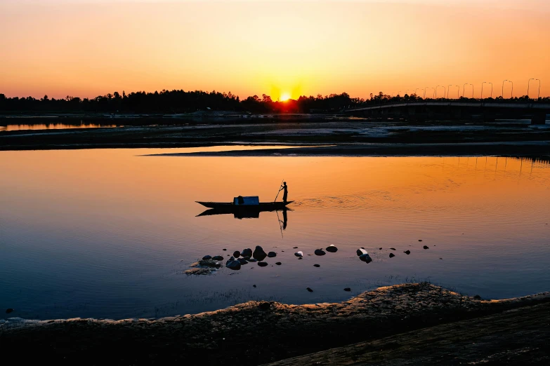 a small boat floating on top of a body of water, a picture, unsplash contest winner, sōsaku hanga, low sun, farming, 2000s photo, guangjian