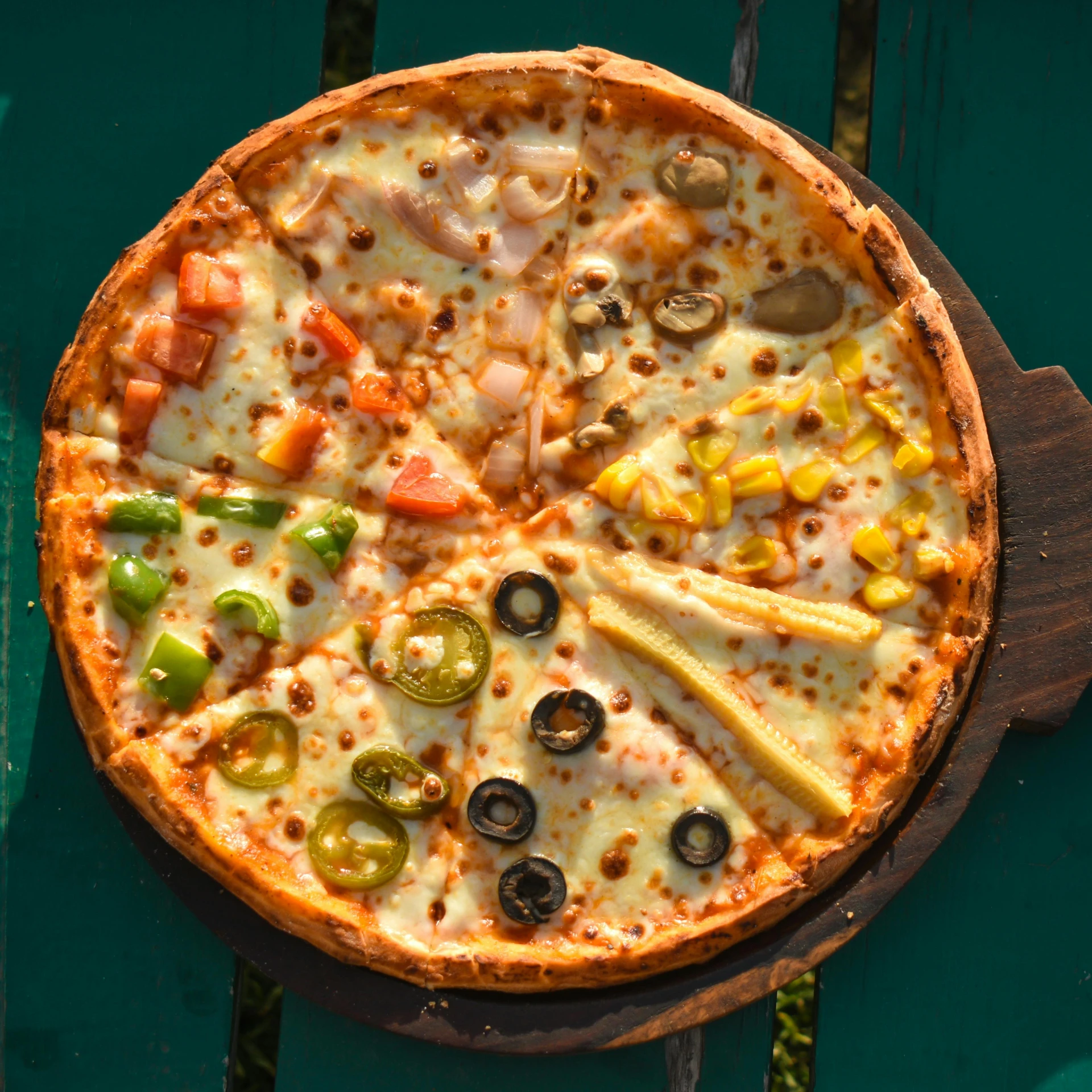 a pizza sitting on top of a wooden cutting board, pizza on a table