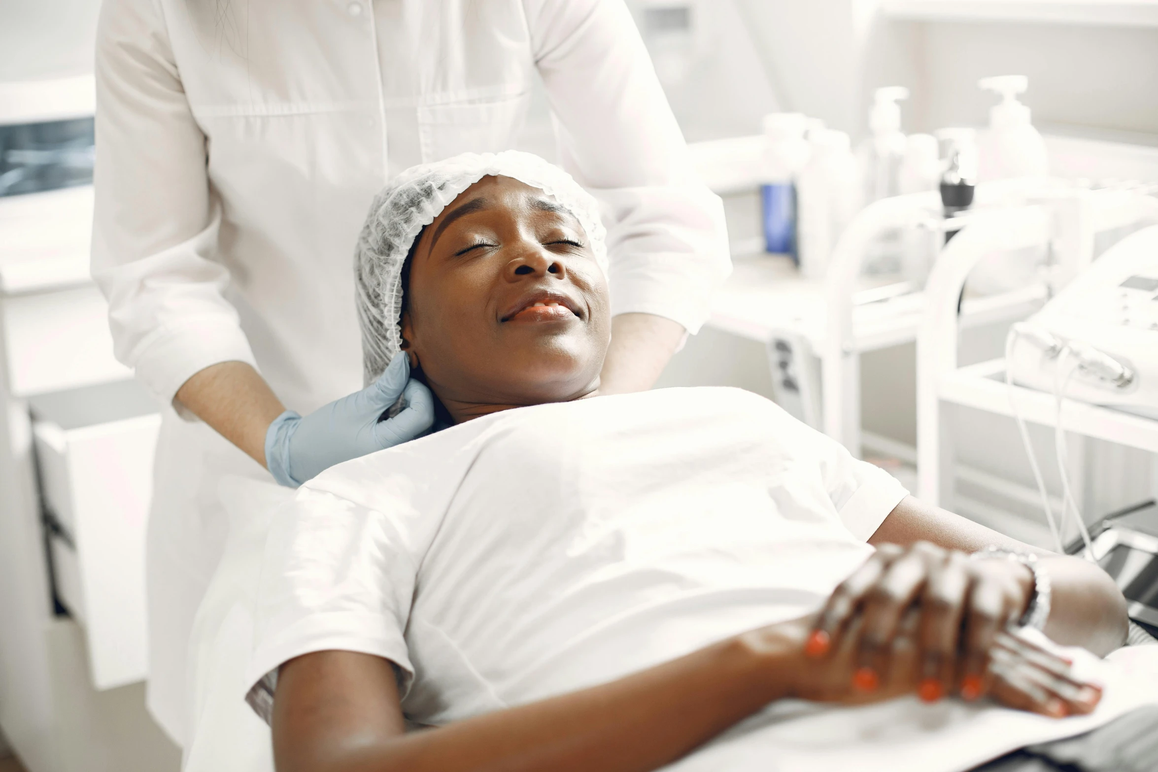 a close up of a person laying on a bed, skincare, on an operating table, african sybil, thumbnail