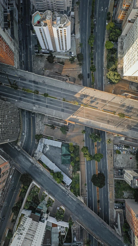 an aerial view of an intersection in a city, by Alejandro Obregón, unsplash contest winner, hyperrealism, sky bridge, collapsed brutalist architecture, brazil, 15081959 21121991 01012000 4k