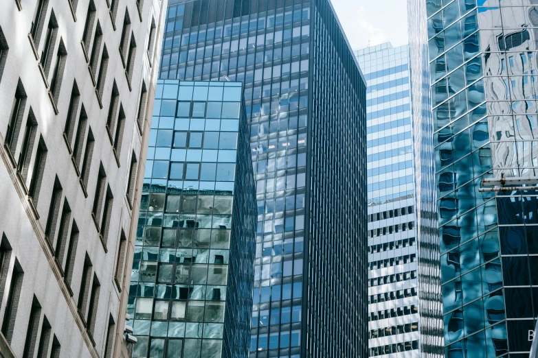 a group of tall buildings next to each other, inspired by Thomas Struth, pexels contest winner, modernism, aquamarine windows, corner office background, montreal, zoomed in