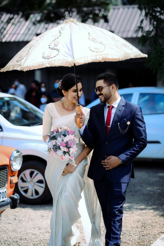 a man and woman standing next to each other under an umbrella, an album cover, pexels contest winner, hurufiyya, sri lanka, luxurious wedding, thumbnail, cars