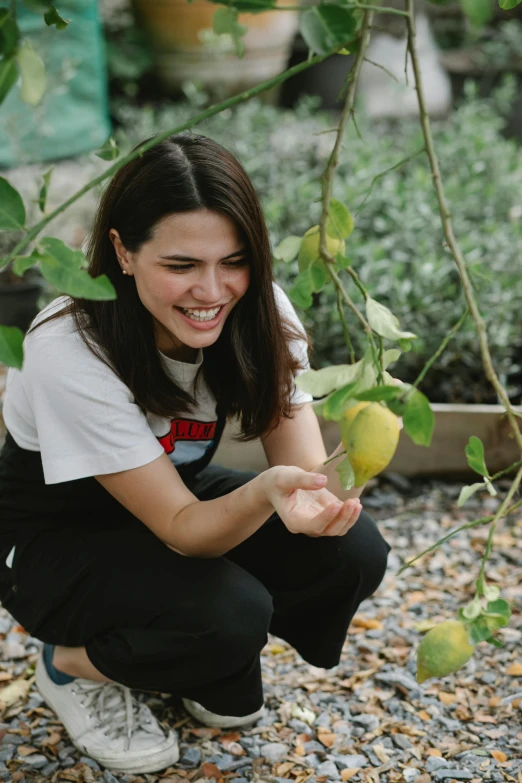 a woman kneeling down next to a lemon tree, portrait of alexandra daddario, mutahar laughing, plating, profile image