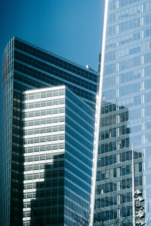 a couple of tall buildings sitting next to each other, inspired by Richard Wilson, modernism, transparent glass surfaces, zoomed in, chicago skyline, architecture award winner